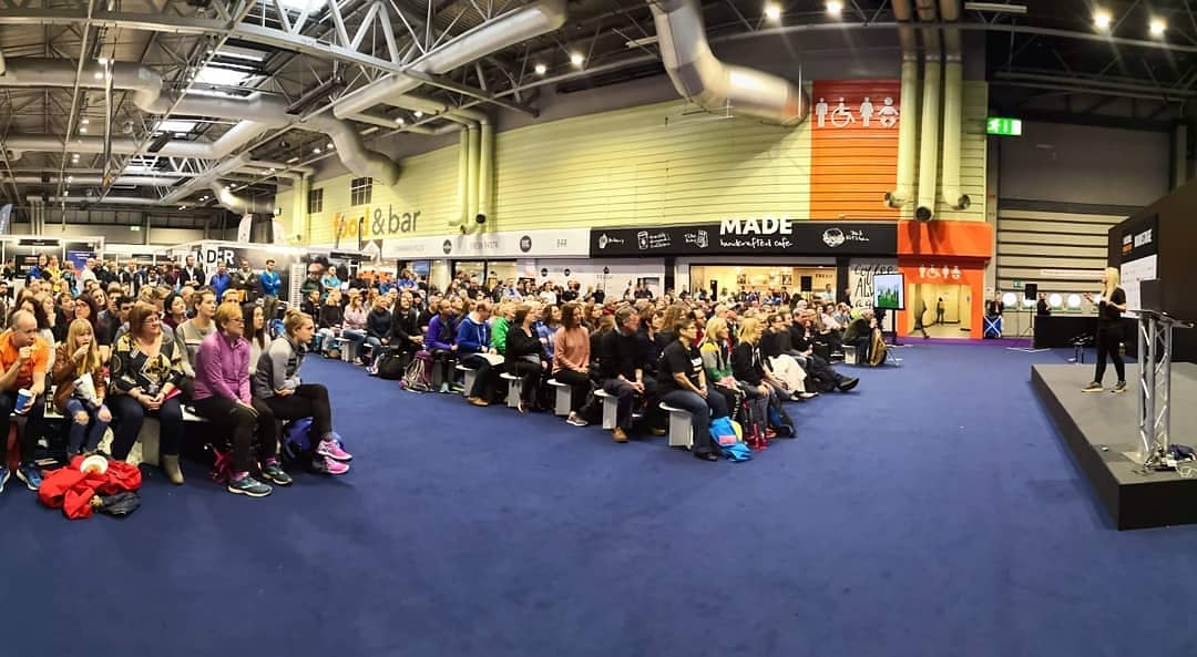 Nikki speaking on stage